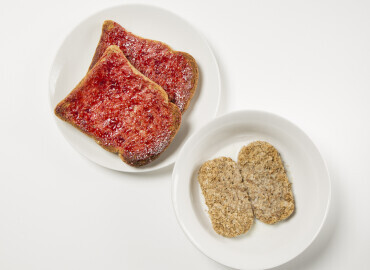 Bowl of wheat bisks and two slices of wholemeal toast with jam