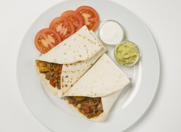 Mexican tortilla wraps with sour cream and guacamole