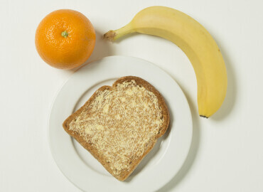 Orange, banana, slice of toast with lower fat spread