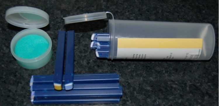 Blue plastic sticks in a clear container.