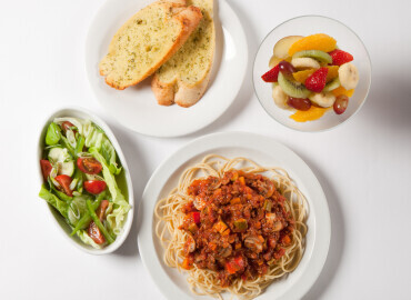 Spaghetti Bolognese with garlic bread, a side salad, followed by fruit salad 