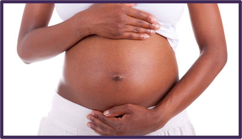 A women with her bare pregnant belly