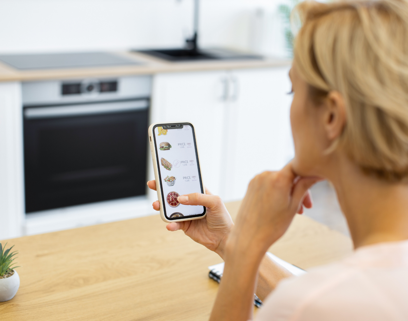 A woman looking through food option on an online food delivery platform.