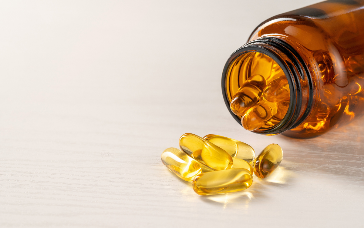 Clear food supplement capsules spilled out onto a table.