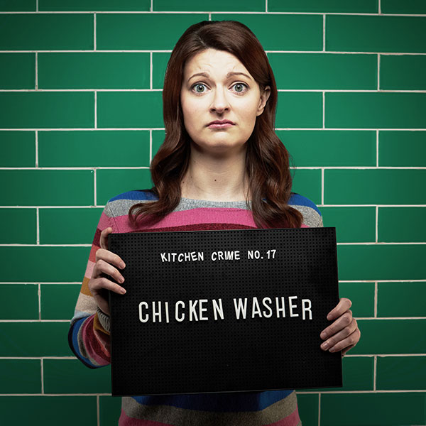 Mock mug shot photograph of a woman holding a sign saying kitchen crimes number 17: chicken washer